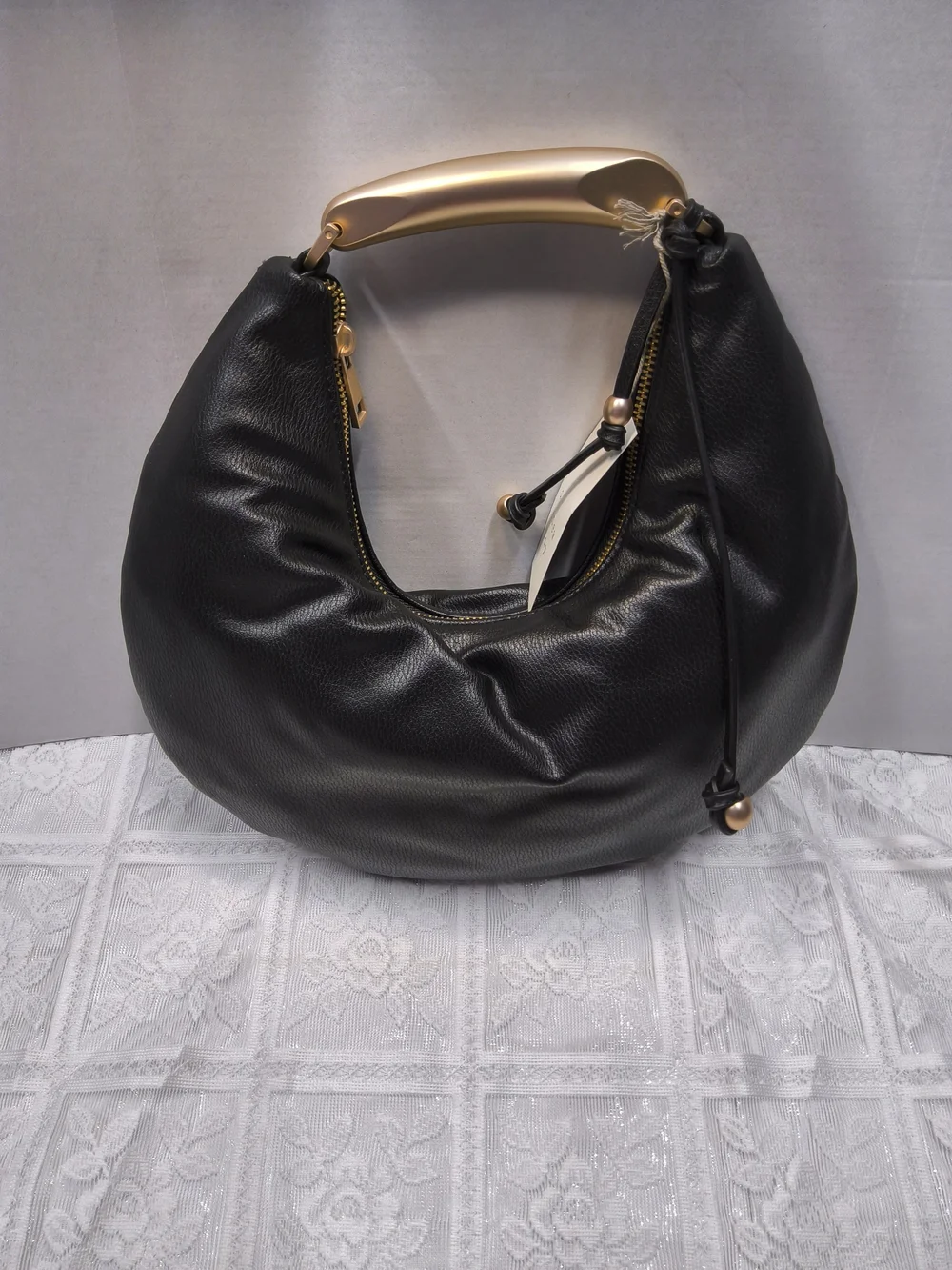 A New Day Crescent Handle Bag in Black with Gold Accent